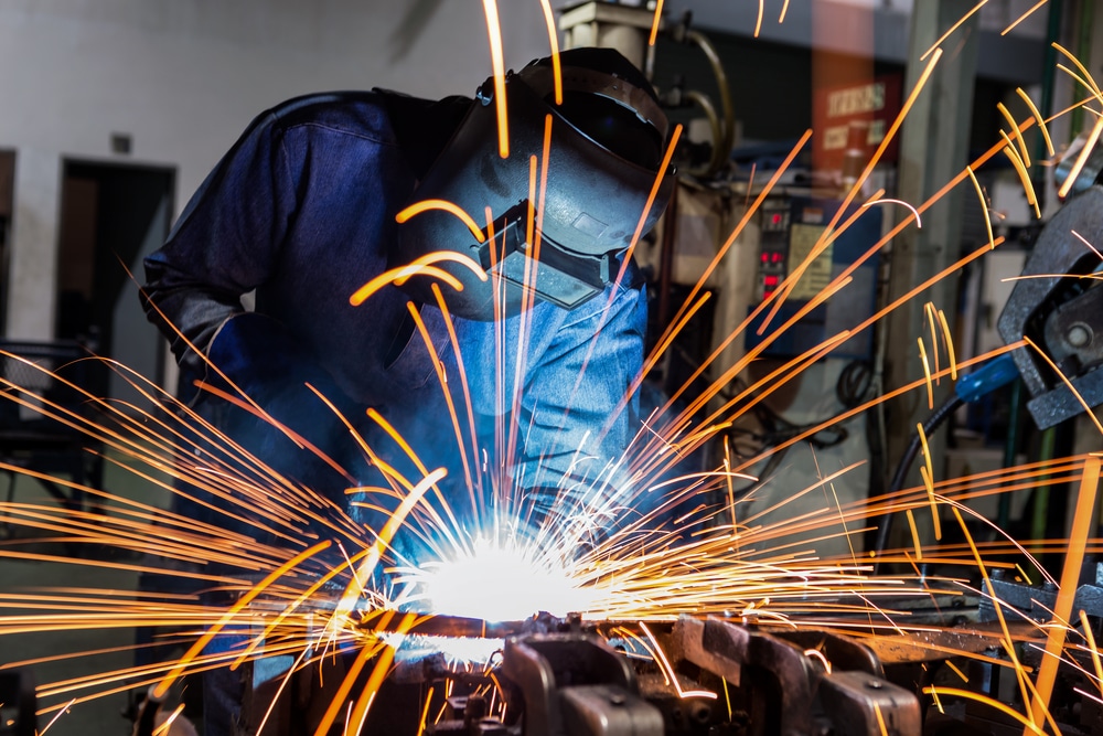 Welder in action welding metal parts